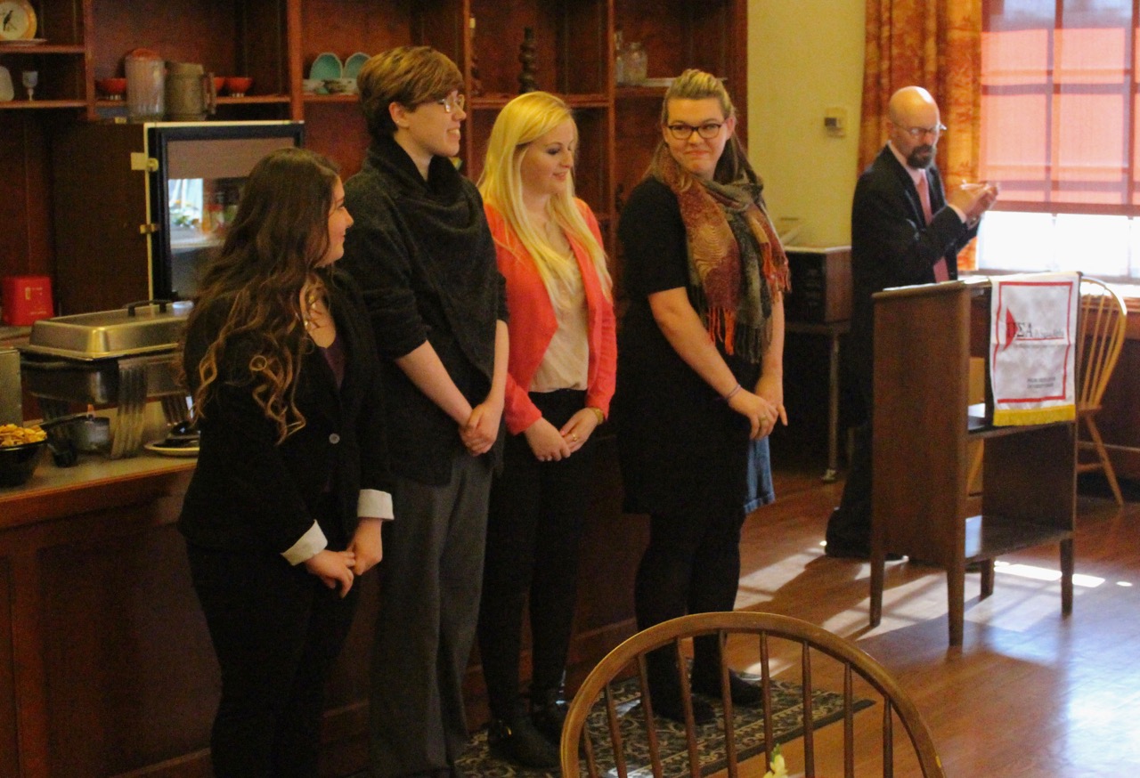 Professor Mark Brewer presents Miranda Roberts, Allyson Eslin, Jaymi Thiabult, and Madison Waterman with their scholarships.