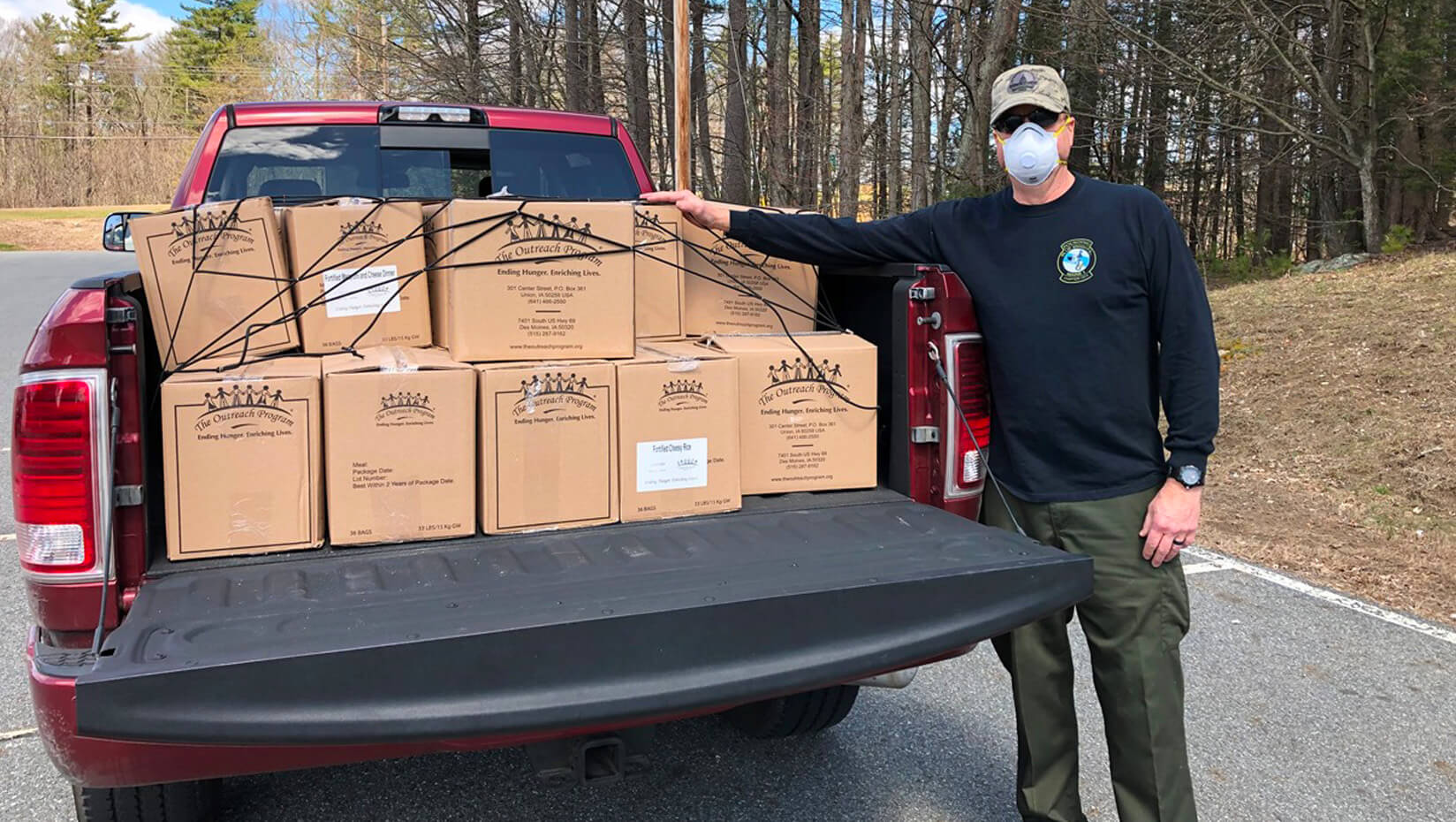 Dave Wight, a member of Blue Knights Maine Chapter 1, with meals packed for distribution through the Good Shepherd Food Bank.