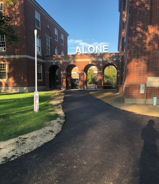 photograph of walkway near Stevens Hall with the word "alone" superimposed onto it