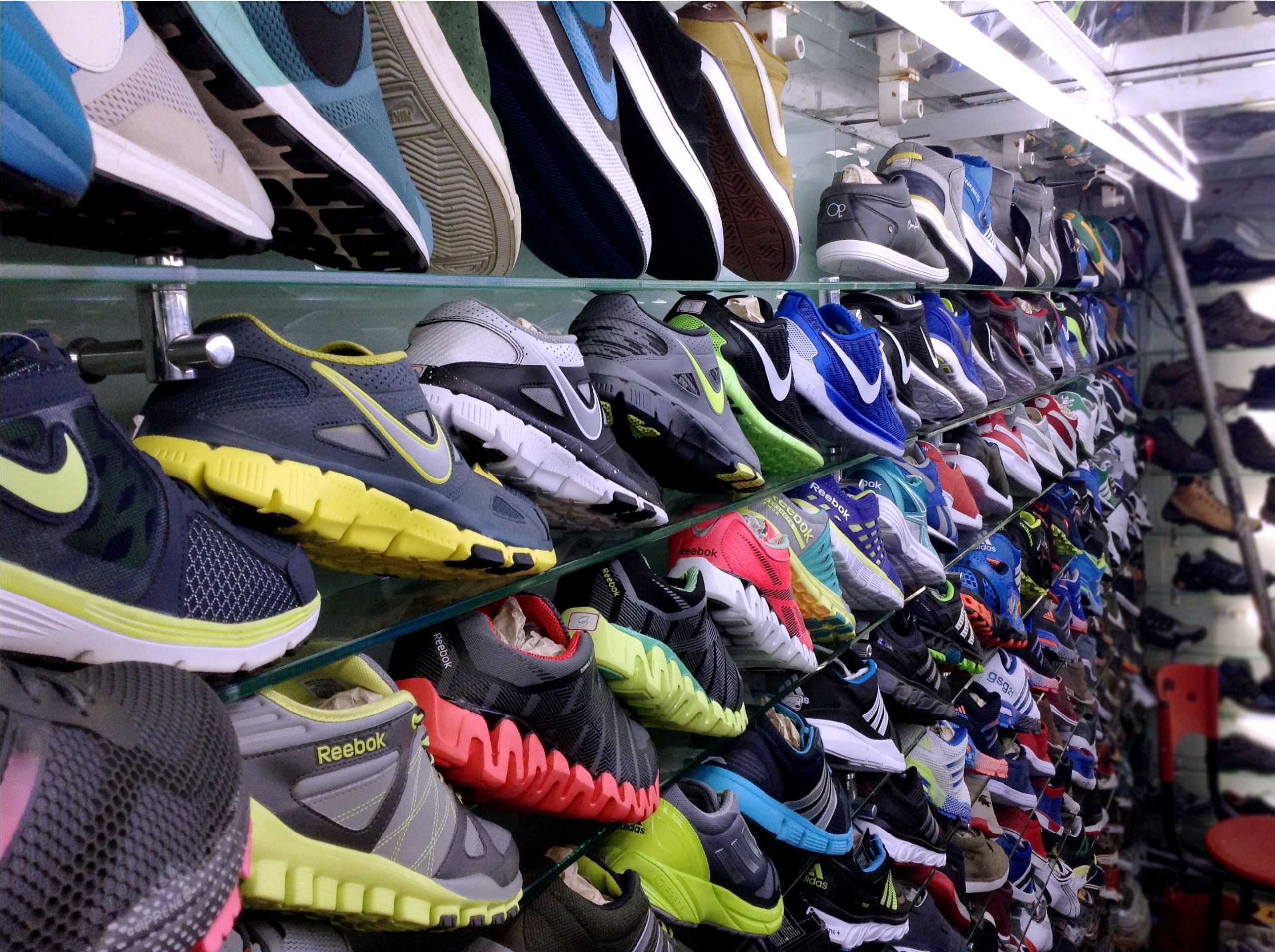 A photo of multiple pairs of shoes on the wall. 