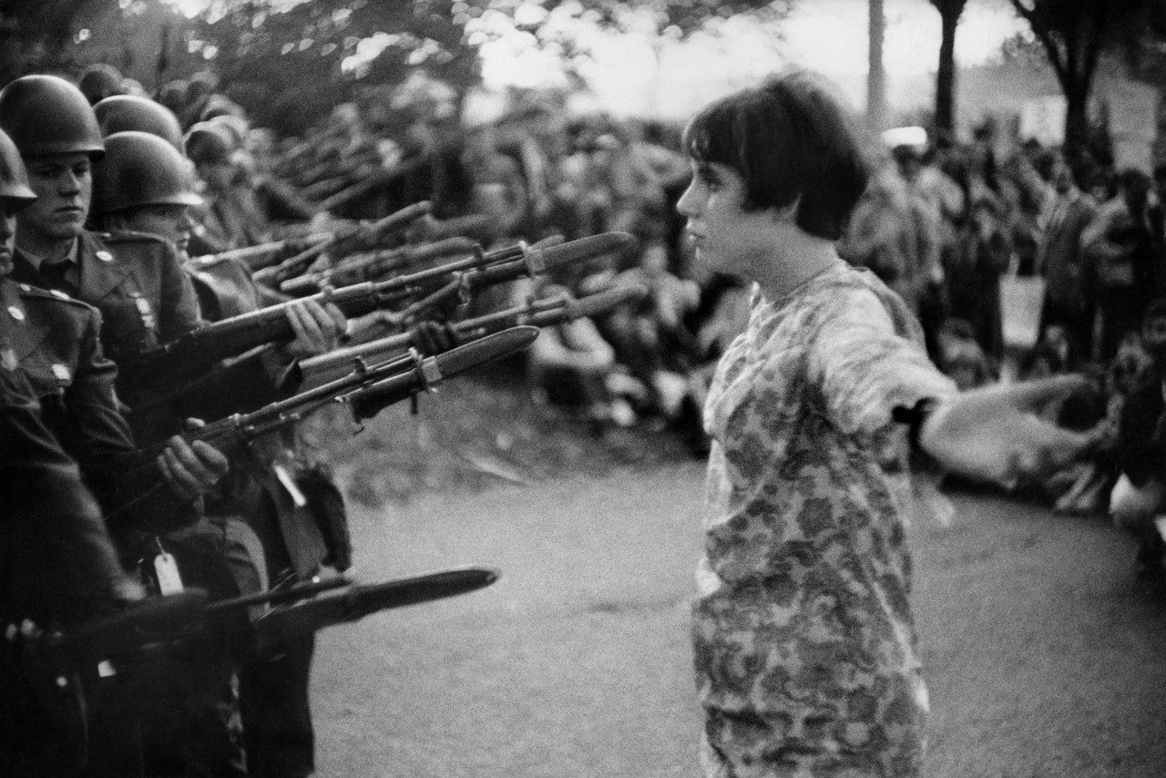 a person standing in front of armed soldiers