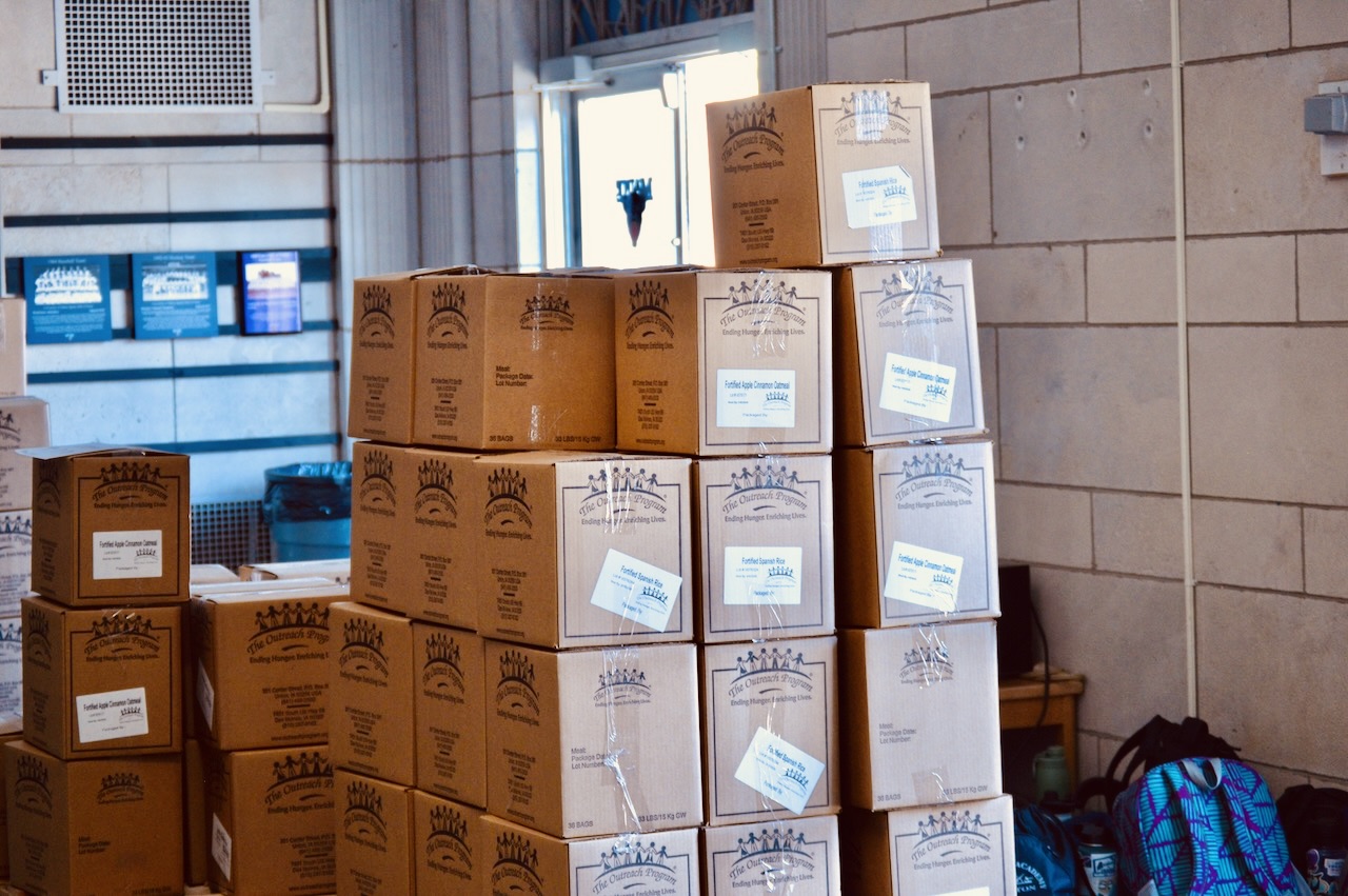 A stack of packed meal boxes, containing thousands of meals, ready to be picked up by food banks.